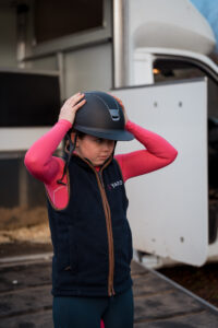 Horse rider wearing her riding hat with safety standards for 2024 